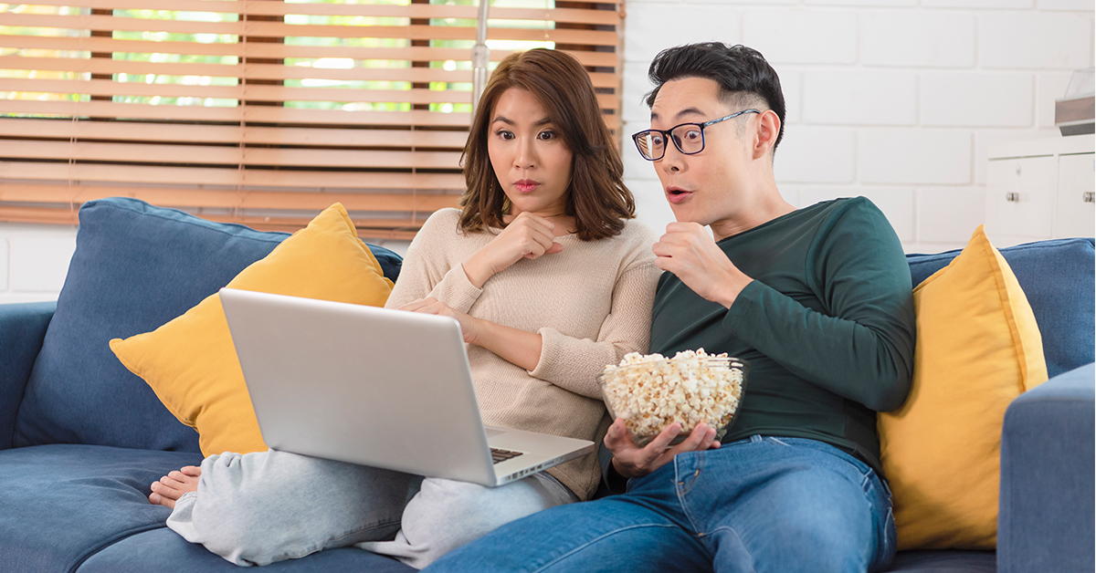 happy couple watching in shock